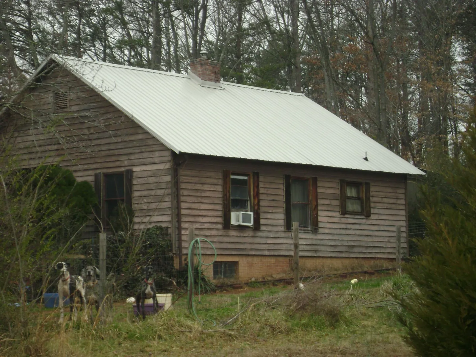 White metal roof on an old wood sided farmhouse, from a Metal Roof Installation job in Paeonian Springs